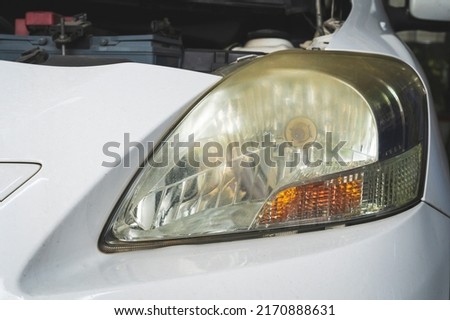 Close-up of yellowed, foggy, eyesore car headlights. Royalty-Free Stock Photo #2170888631