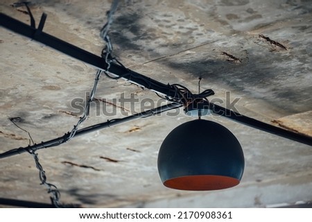 Black iron lamp hanging from the ceiling.
