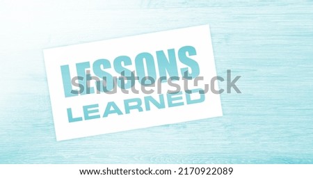 blank card with text Lessons learned on wooden background. Business concept. Royalty-Free Stock Photo #2170922089