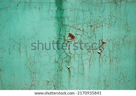 Turquoise (blue, green) texture of cracked, weathered paint on an old rusty metal plate. Close-up. Space for text, background for design. Royalty-Free Stock Photo #2170935841