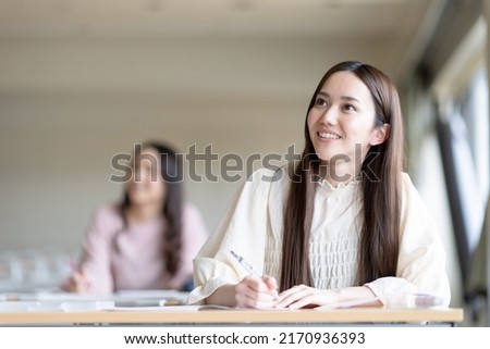 University students taking classes in the lecture room Royalty-Free Stock Photo #2170936393