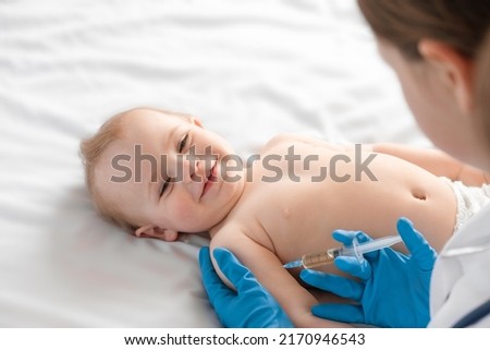 Doctor vaccinating baby in clinic. Little baby get an injection. Pediatrician vaccinating newborn baby. Vaccine for infant child. Child's Immunization, Children's Vaccination, Health concept. Royalty-Free Stock Photo #2170946543
