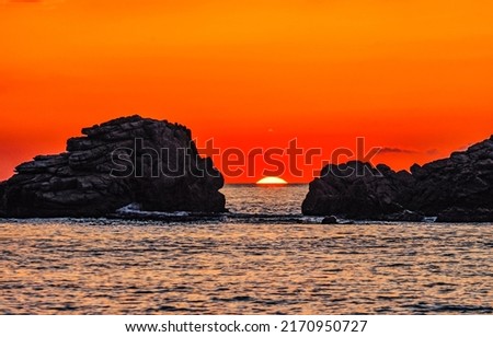 Sunset over the sea horizon. Sea rocks at sunset. Sunset sea rocks. Sundown over sea horizon Royalty-Free Stock Photo #2170950727