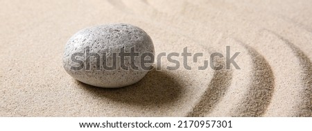 Stone on sand with lines. Zen concept