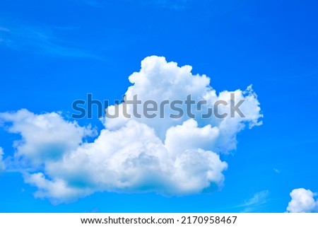 One isolated white cloud in a blue sky. Heaven background. Wallpaper. Beautiful cloudscape. Cumulus clouds. Weather forecast. Outdoor natural landscape. Banner. Dreams. Summer season.