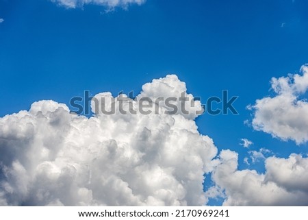Photography of beautiful storm clouds, cumulus clouds or cumulonimbus against a clear blue sky. Full frame, sky only. Royalty-Free Stock Photo #2170969241
