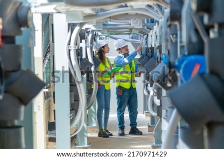 Engineer under checking the industry chilled water fan coil unit air conditioner is water cooling tower air chiller HVAC system of large industrial building to control air system Royalty-Free Stock Photo #2170971429