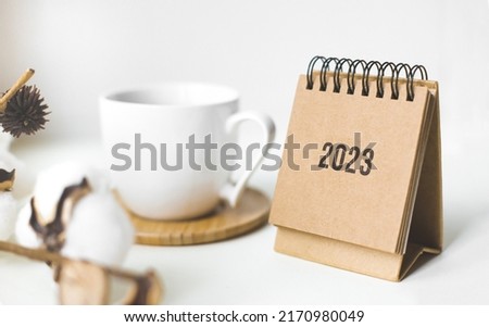 Close up calendar 2023 on table with coffe cup.