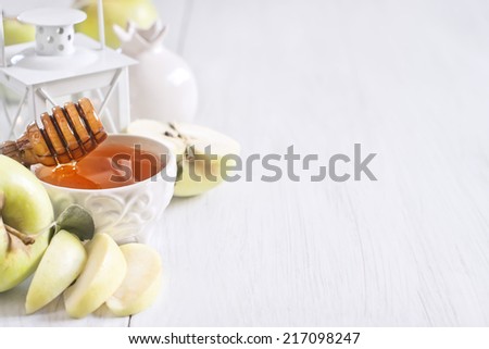 Apple and honey, traditional food of jewish New Year celebration, Rosh Hashana. Selective focus. Copyspace background. High key. Royalty-Free Stock Photo #217098247