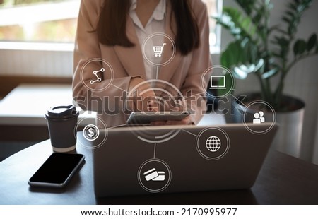 Business women using tablet with laptop and smartphone on desk in modern office with virtual interface graphic icons network diagram.