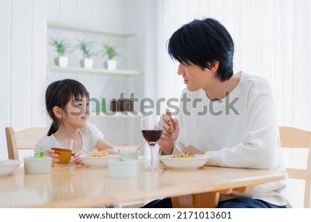 Little girl eating with daddy Royalty-Free Stock Photo #2171013601