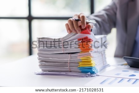 Business Documents, Auditor businesswoman checking searching document legal prepare paperwork or report for analysis TAX time,accountant Documents data contract partner deal in workplace office Royalty-Free Stock Photo #2171028531