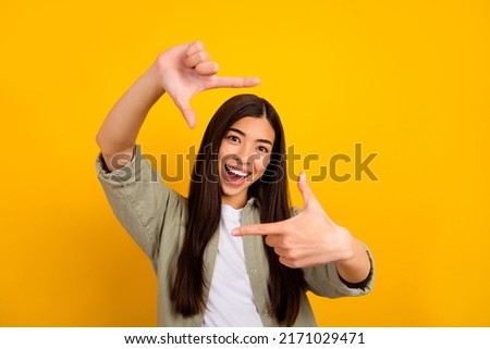 Photo of young good mood overjoyed young photographer lady take picture of you isolated on yellow color background