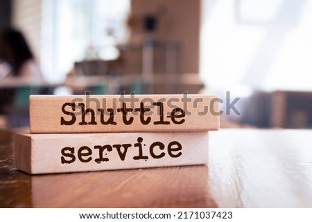 Wooden blocks with words 'shuttle service'. Business concept