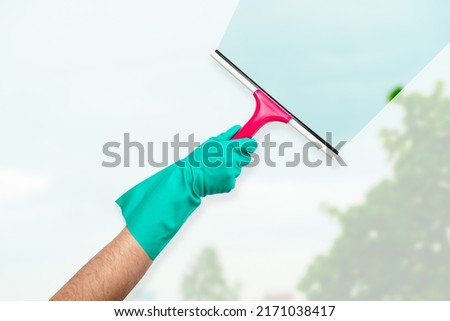 Windows cleaning service, hand in gloves Royalty-Free Stock Photo #2171038417