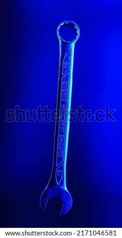 Blue Spanner for 19 made of chrome vanadium steel flying in the air on a blue background. Background picture. Isolated spanner. Mark of metal is present - "chrome vanadium" - this is not TRADEMARK.