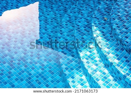 Vinyl lined pool. Outdoor photo of a mosaic-patterned residential swimming pool. Swimming pool with steps. Feeling of moving water.
