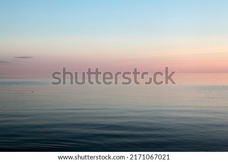 Clear blue sky above calm sea during the dusk. Selective focus. High quality photo