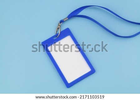 Blue plastic badge with space for text on blue background.
