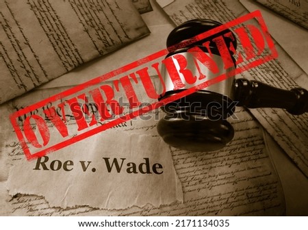  Roe v Wade news headline with gavel and Overturned stamp on a copy of the United States Constitution                               Royalty-Free Stock Photo #2171134035