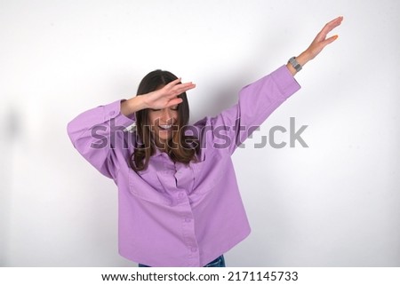 Photo of funky young beautiful caucasian woman wearing pink jacket over white background show disco move dab