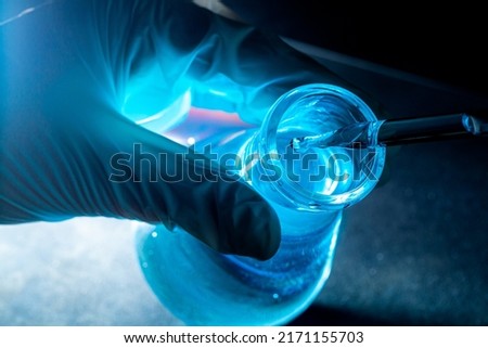 Blue science experiment glass tube,Researchers with chemistry test tubes in a liquid glass lab for analytical, medical, pharmaceutical and scientific research concepts Royalty-Free Stock Photo #2171155703