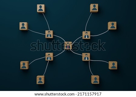 Wooden blocks connected to each other with icons of people, in the center an important character and other people who depend on him. Business hierarchy concept.
