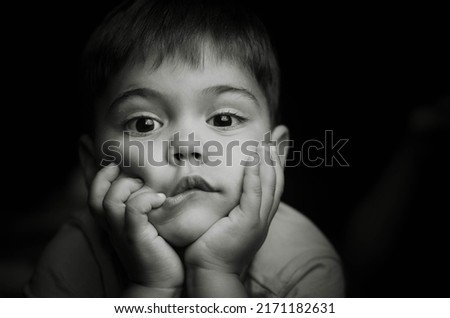 Striking black and white portrait of 
 3 years old boy