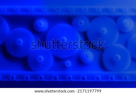 Plastic gears compilation on a neon blue background. Spare parts for your RC toy. Background picture.