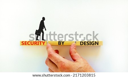 Security by design symbol. Concept words Security by design on wooden blocks on a beautiful white table white background. Businessman hand. Business finacial security by design concept. Copy space.