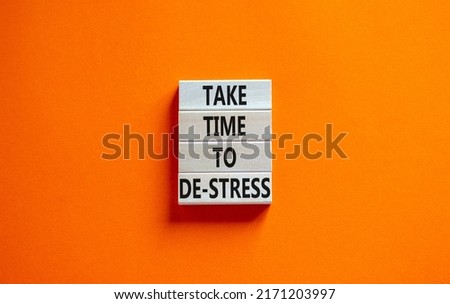 Take time to de-stress symbol. Concept words Take time to de-stress on wooden blocks. Beautiful orange table orange background. Psychological business and take time to de-stress concept. Copy space.