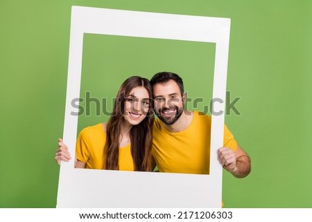 Photo of two cheerful nice partners hands hold paper album set card isolated on green color background