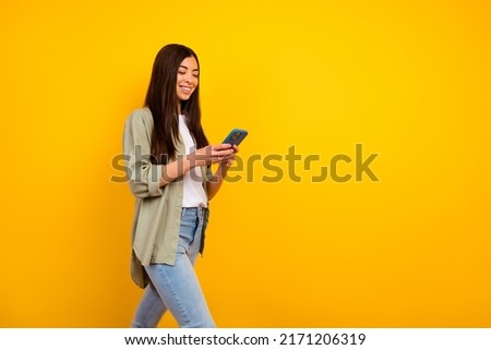 Photo of young charming filipino girl walking go on trip adventure use gps locator isolated on yellow color background
