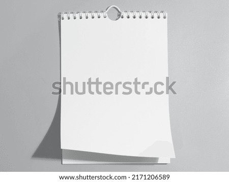 A paper white calendar stands on the table. Mock Up 3D Rendering