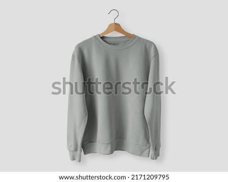 Blank long sleeve shirt hanging on the wall mock up template Royalty-Free Stock Photo #2171209795