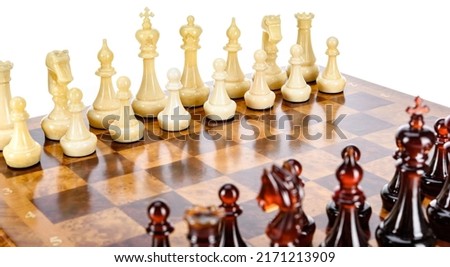Natural amber different chess pieces figures standing on brown stone board. Close up game concept competition, Classic Gambit Tournament of confrontation.