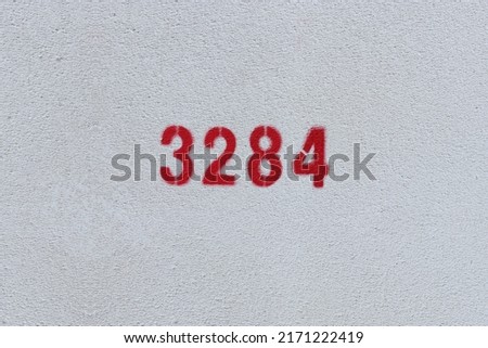 Red Number 3284 on the white wall. Spray paint.
