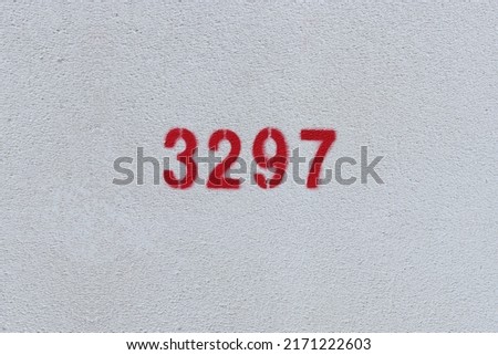 Red Number 3297 on the white wall. Spray paint.
