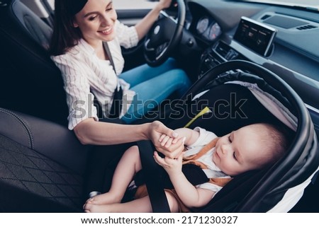 Photo of adorable cheerful mom small daughter wear casual outfits riding soothing sitting inside automobile vehicle