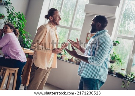 Photo of cheerful friendly businessman talking discussing problems indoors workplace workstation restaurant