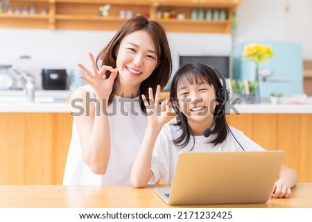 asian girl studying with a PC,correspondence course, mother and daughter