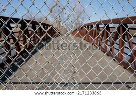 Abstract industrial steel gate fence. Gated bridge walkway industrial background. Minimal street photography overpass bridge. 