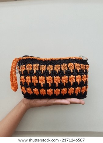 Handmade knitting bag with orange and black colours