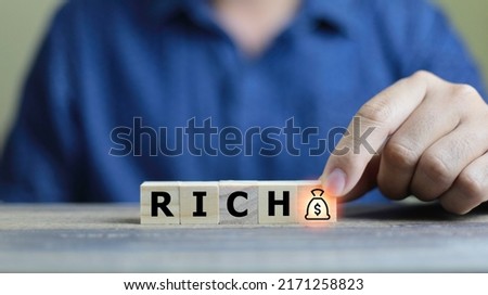 ิbusiness man making rich text in wooden cube