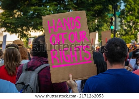 Protestor holds Sign "Hands off our Rights" displayed during Protest in Front of US Supreme Court Building after Court Ruling to Ban Abortions