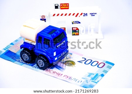 The Toy car on 2000 Ruble banknotes on station gas,The concept of paying for gas in rubles.