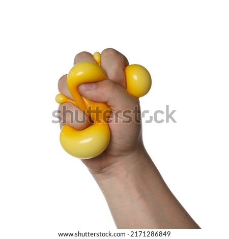 Man squeezing yellow stress ball on white background, closeup Royalty-Free Stock Photo #2171286849