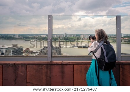 Taking pictures on the roof of the MAS (Museum aan de Stroom). It is a museum located along the river Scheldt in the Eilandje district of Antwerp, Belgium.  Royalty-Free Stock Photo #2171296487