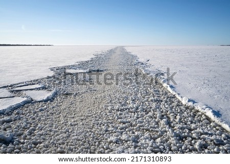 A trail of broken ice made by an icebreaker, sailing the baltic sea. Royalty-Free Stock Photo #2171310893