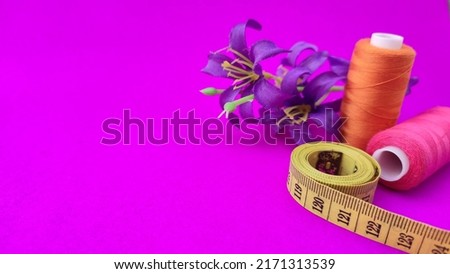 sewing tools on purple background